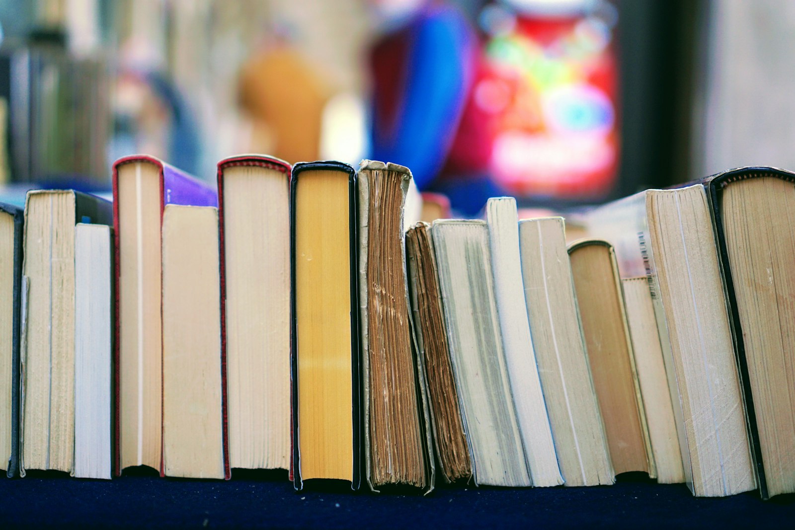 Collection of open books on a wooden surface, representing different study methods