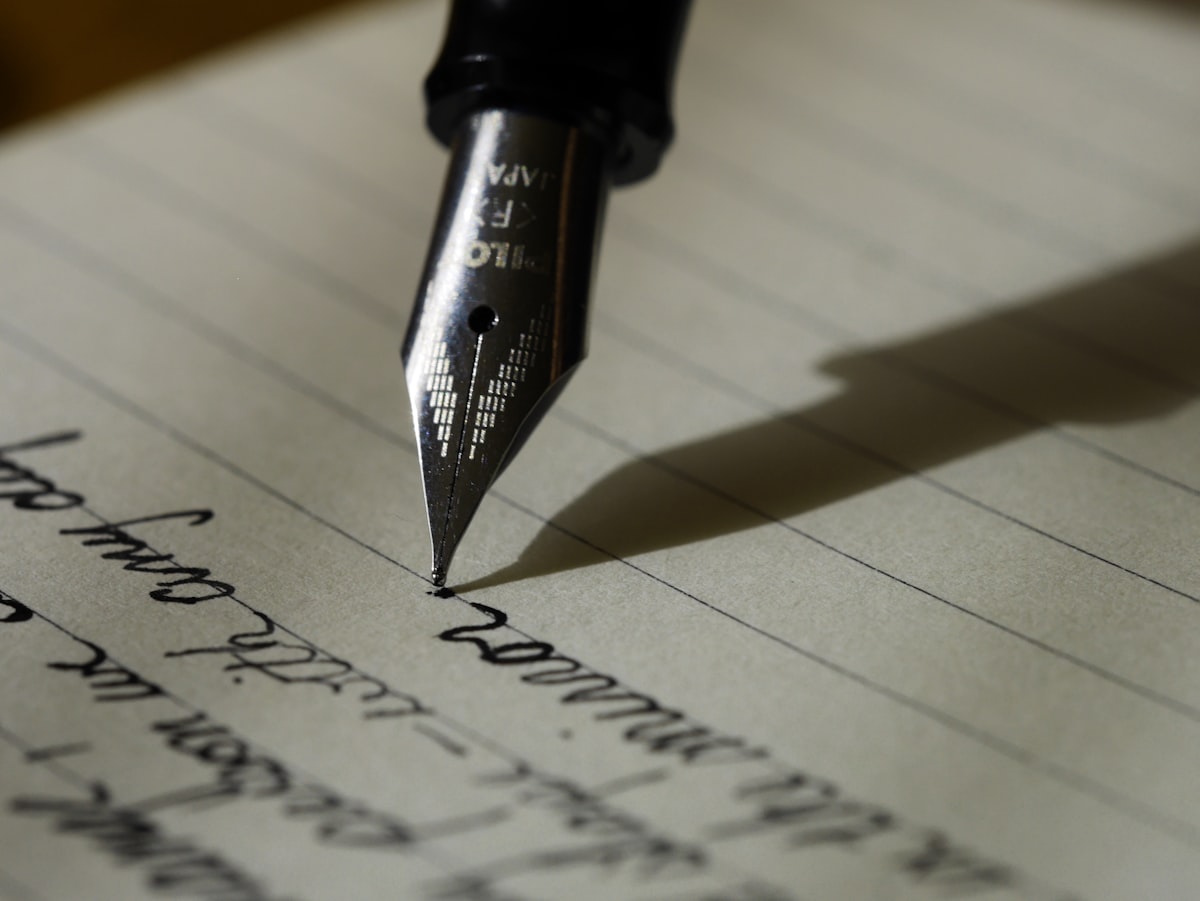 Student writing notes rapidly on paper during study session