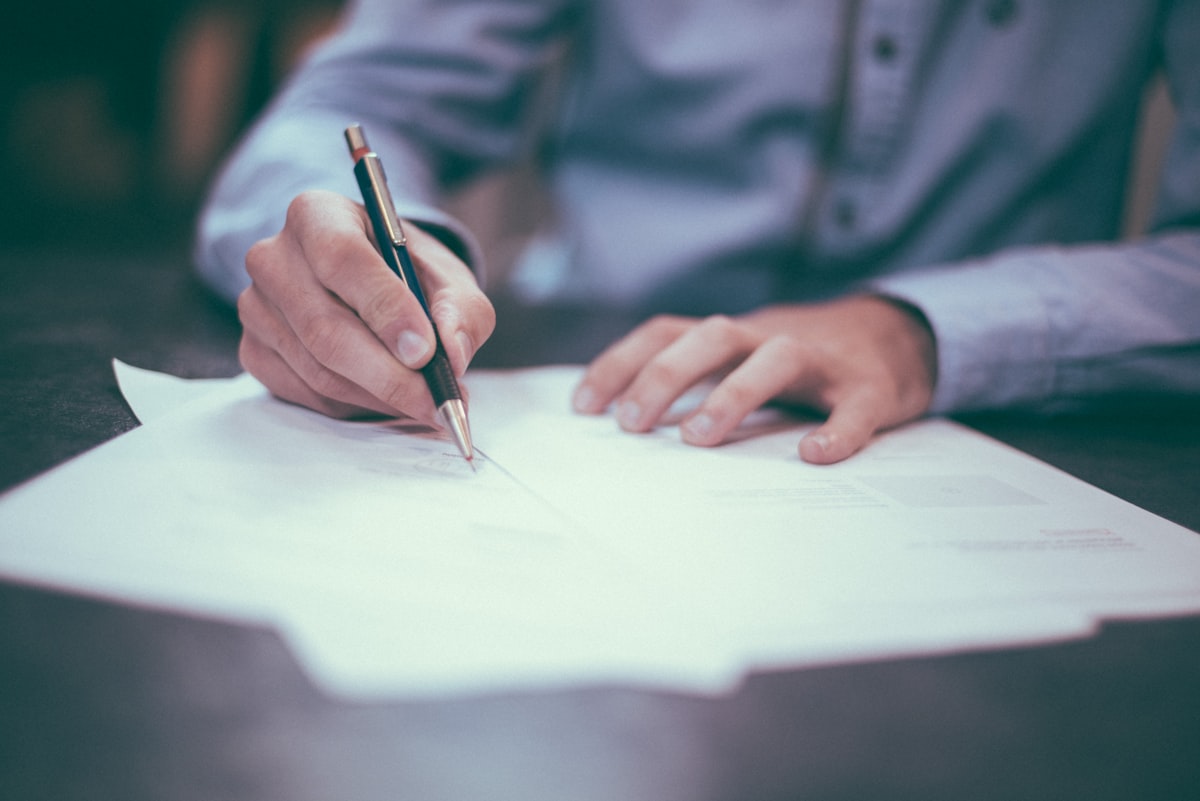 Professional reviewing insurance and risk management documents at a desk