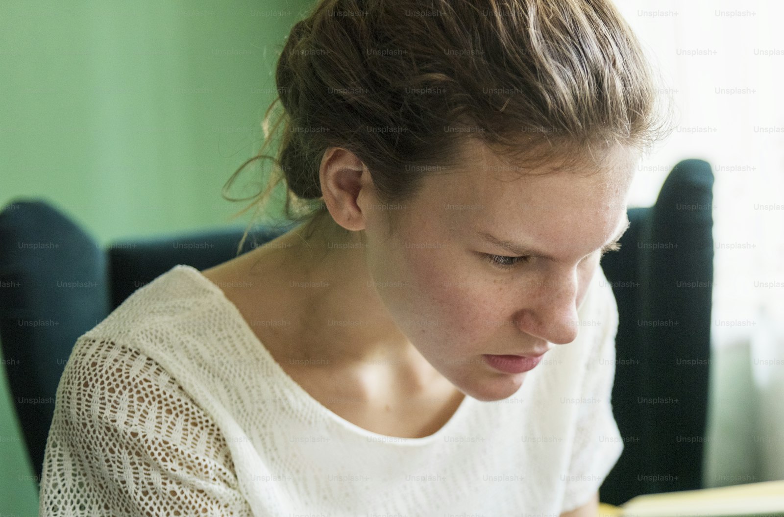 Person reading a book at home in a comfortable, focused setting