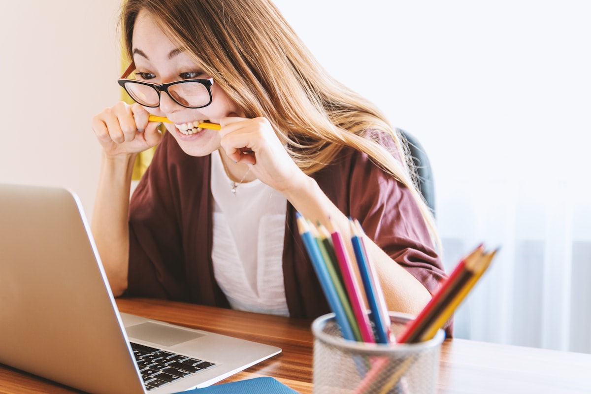 Student concentrating intensely while taking an exam at a computer