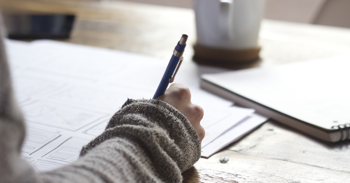 Focused student studying efficiently at a clean desk with a timer
