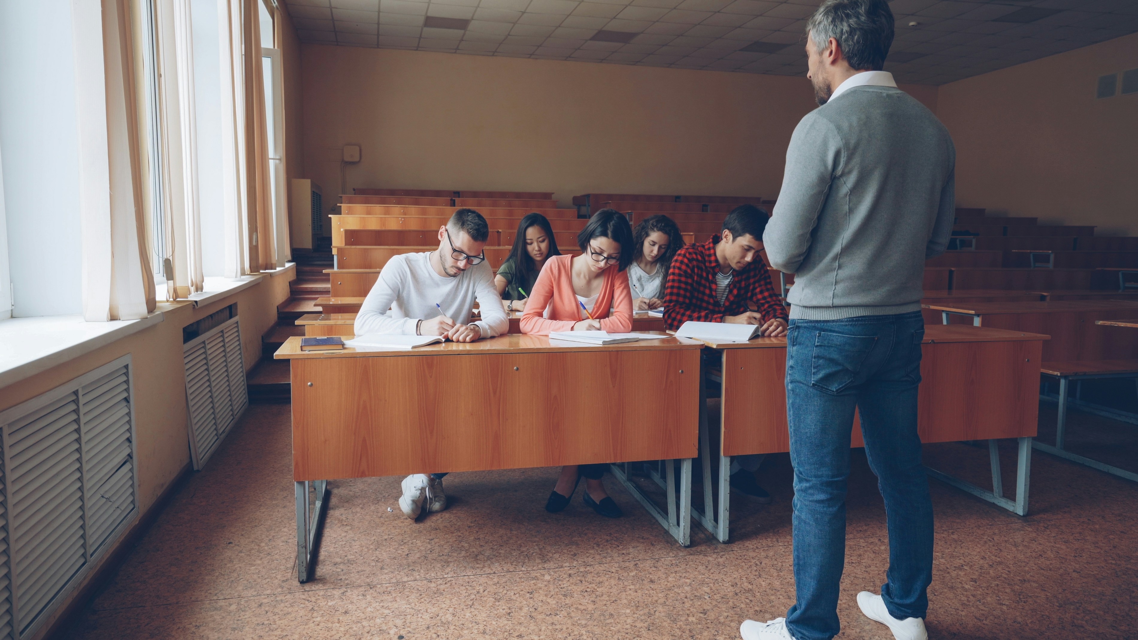 Students writing in an exam hall