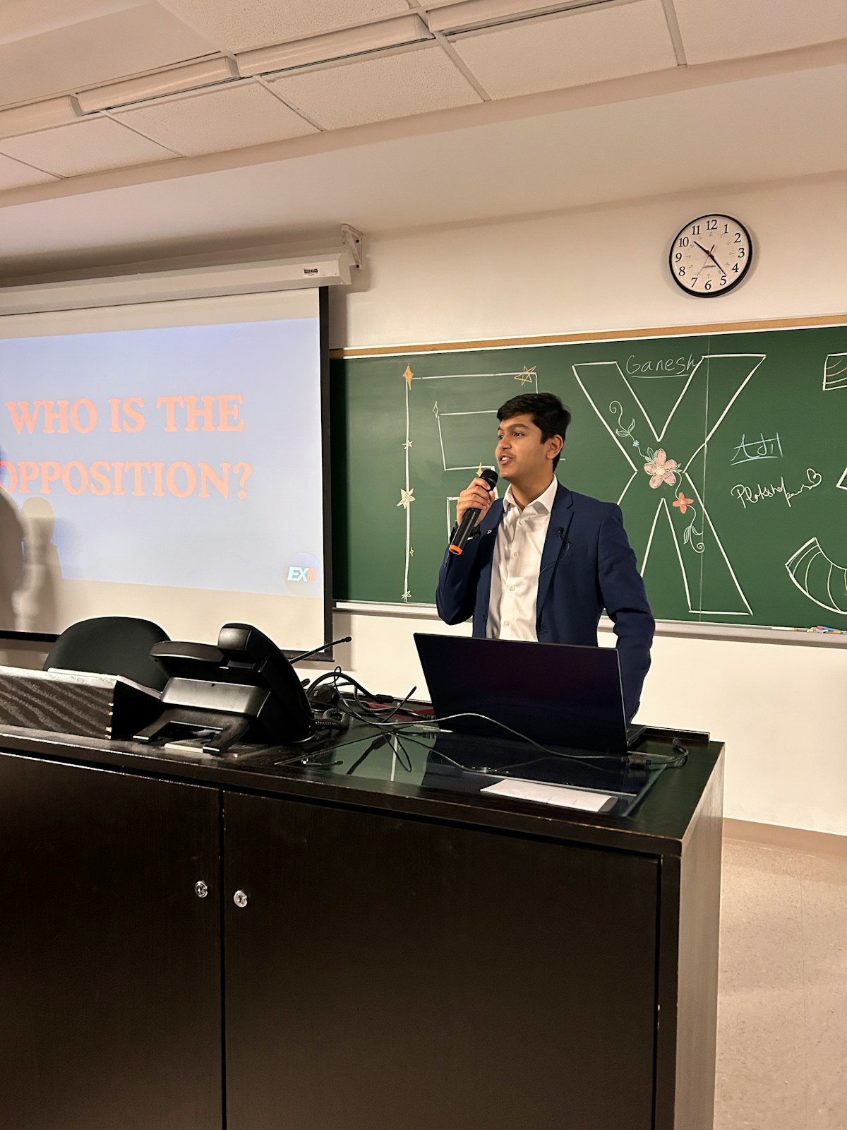 Student presenting and answering questions in front of a classroom during an oral assessment