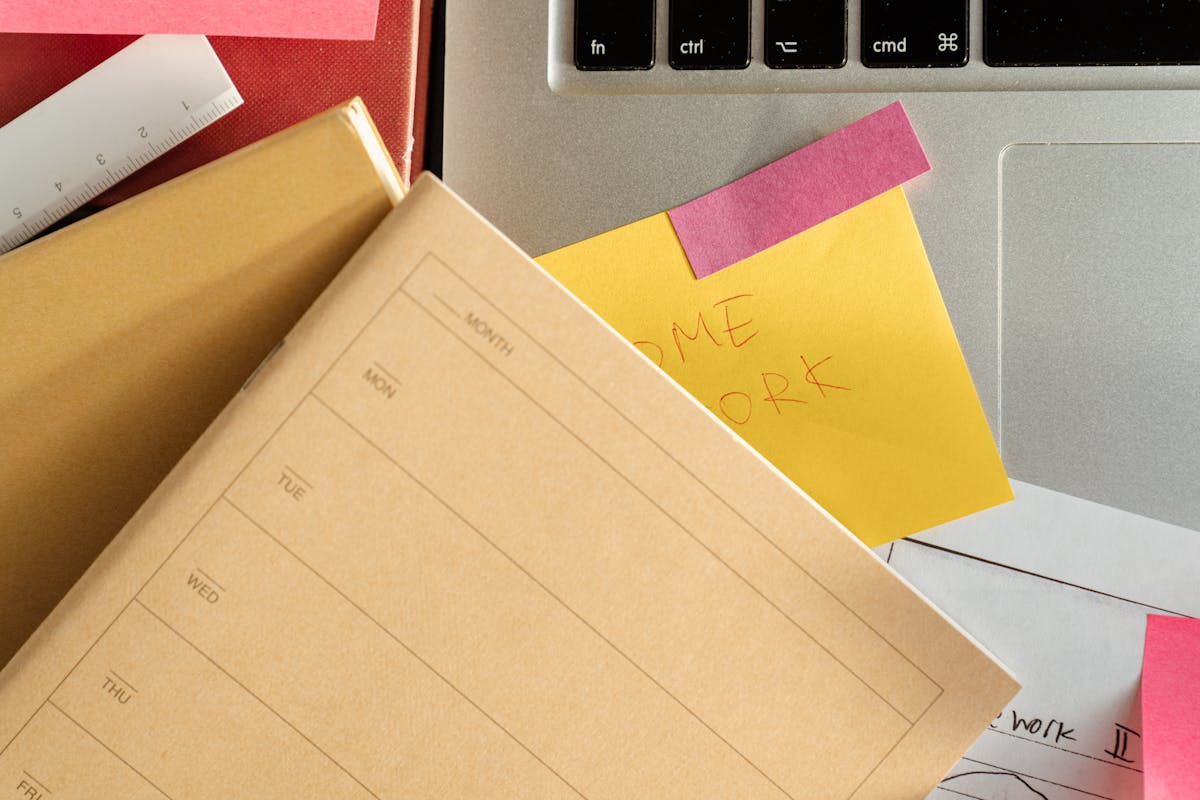 Sticky notes and organized study materials on laptop screen