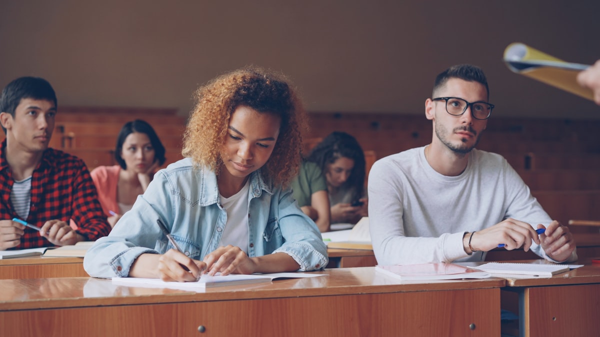 Students studying in a lecture hall taking notes