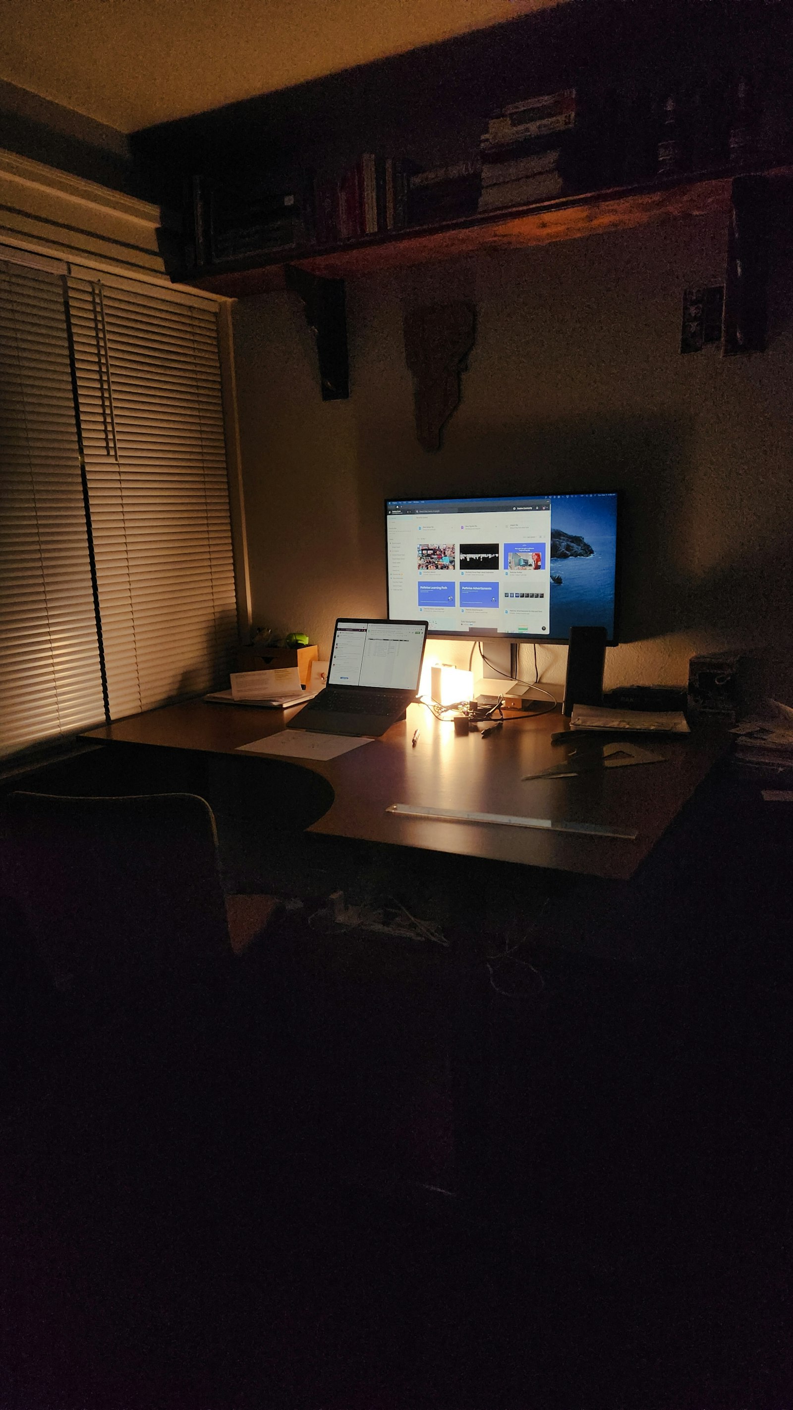 Desk lamp illuminating a workspace at night representing late-night studying