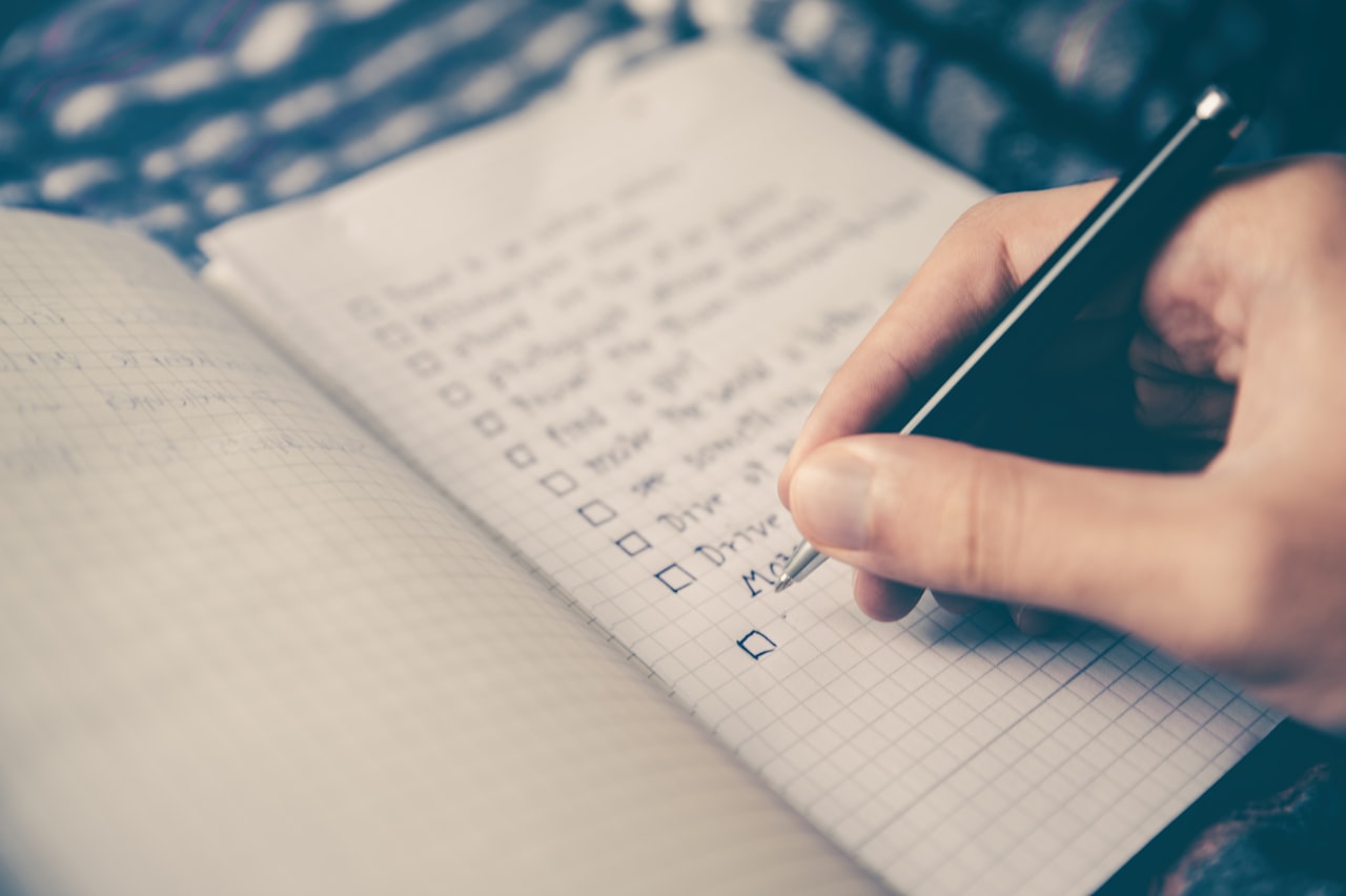 Person sitting at a desk with an open notebook, getting ready to study