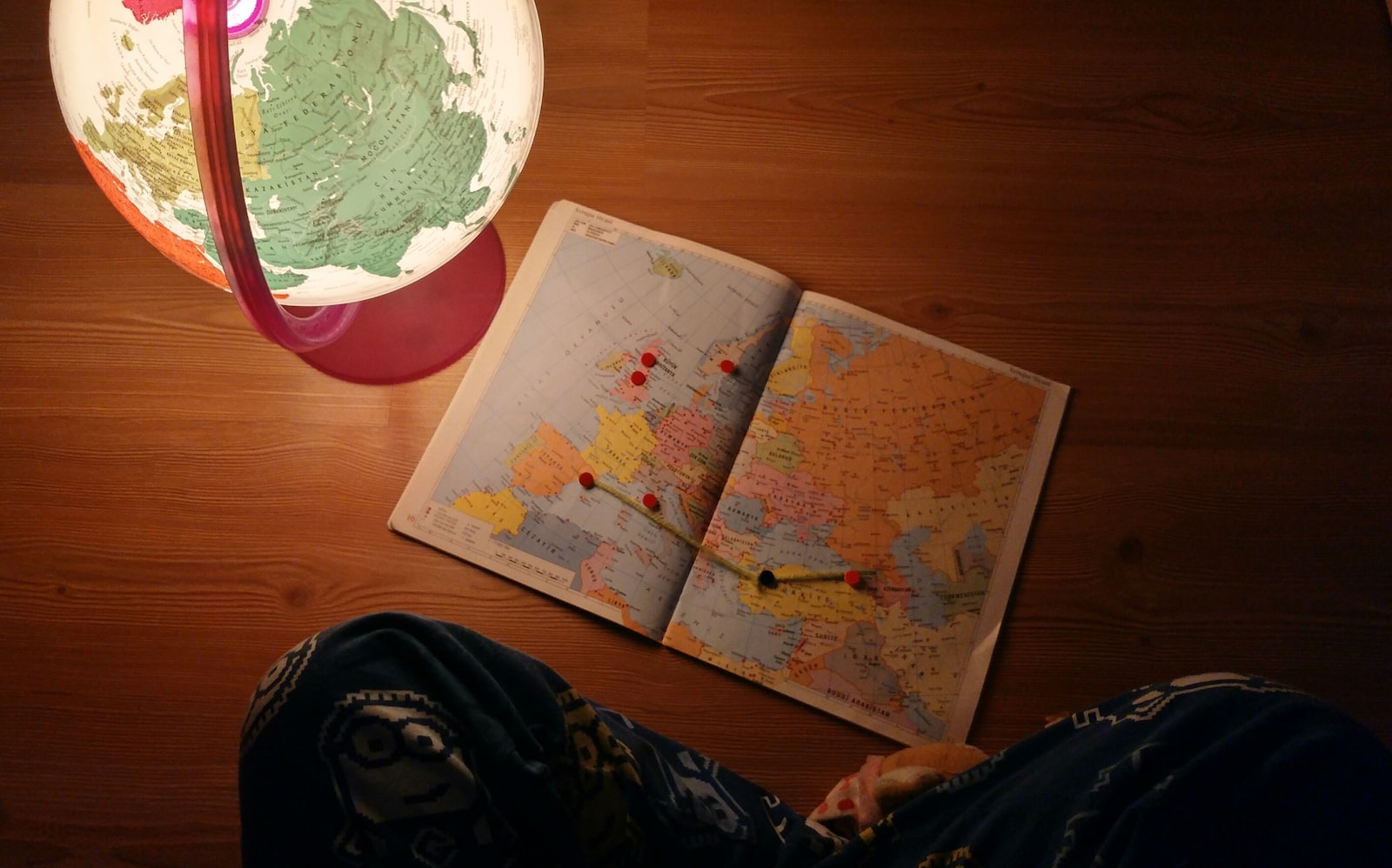 World map and desk globe representing international relations study