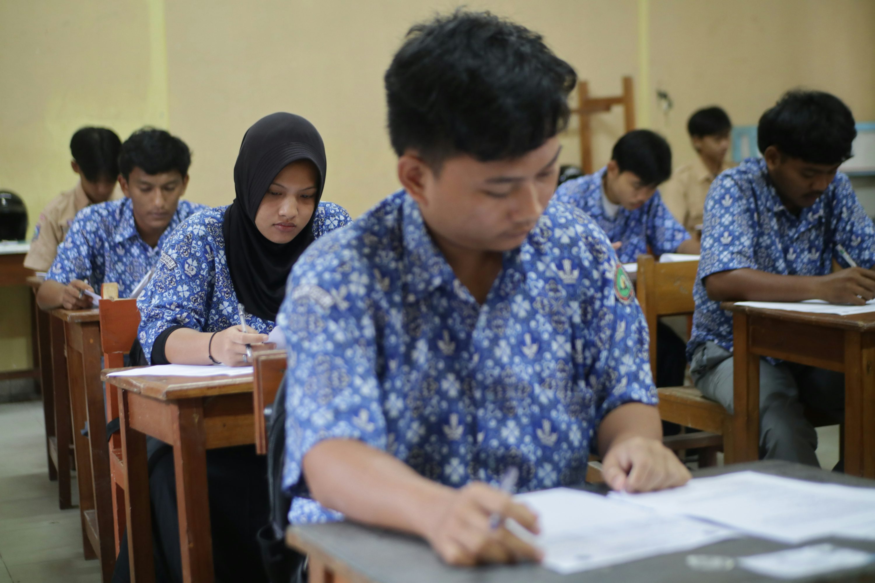 Students focused and taking a test in a professional setting