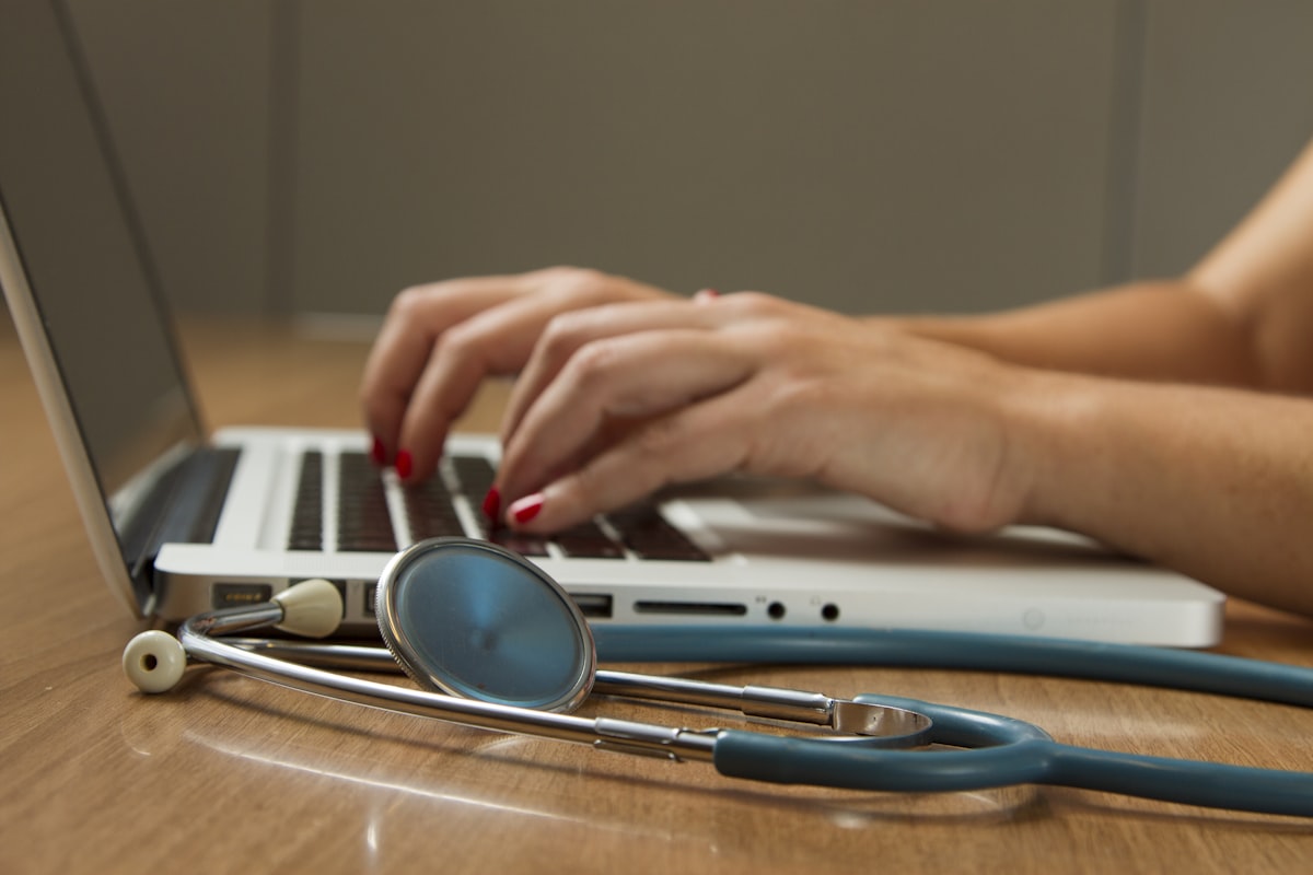 Medical student studying anatomy textbooks and notes at a desk