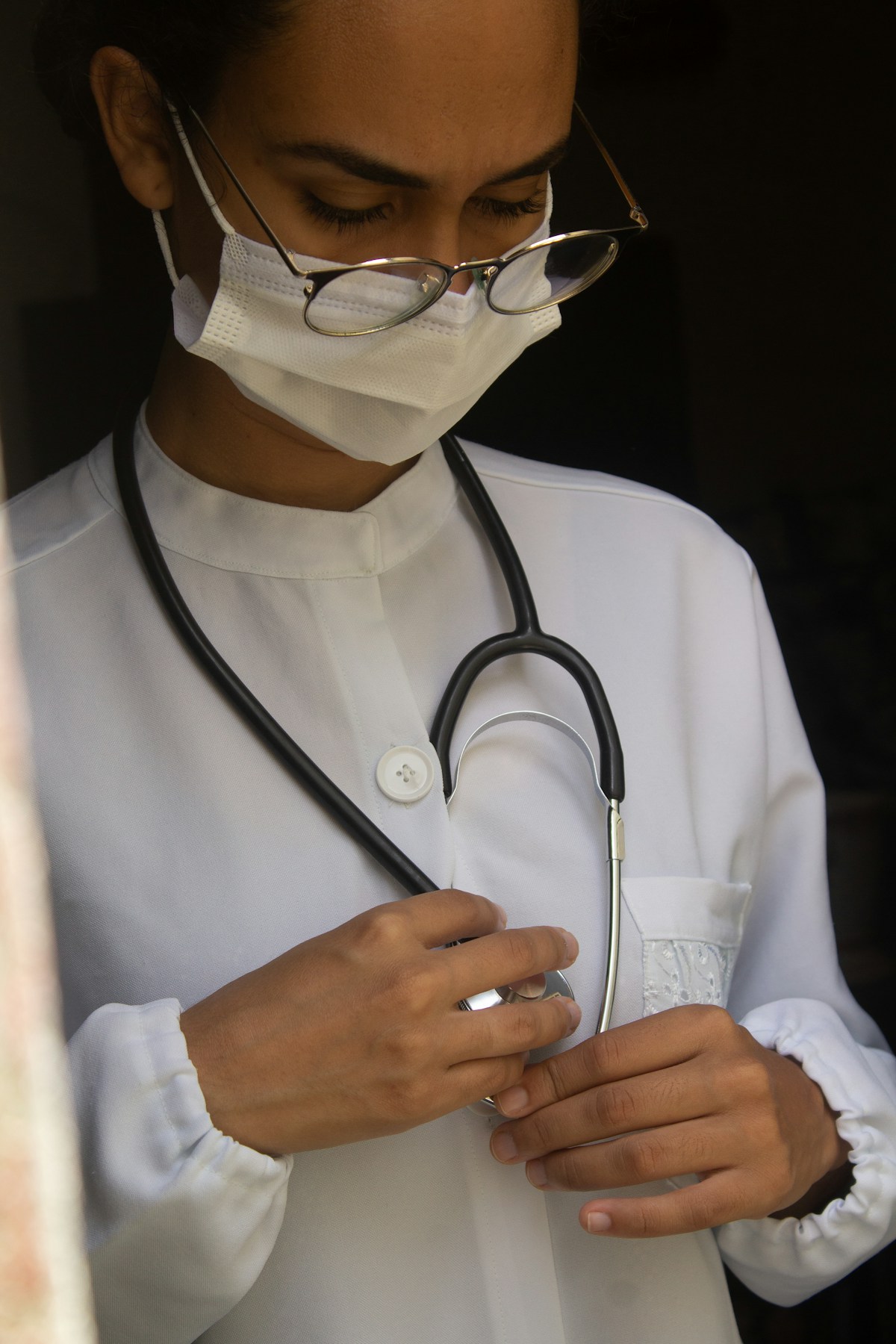 Medical student holding a stethoscope while preparing for a clinical exam