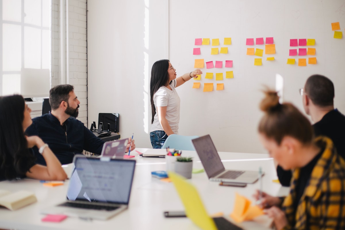 Team members collaborating and learning together in a modern office